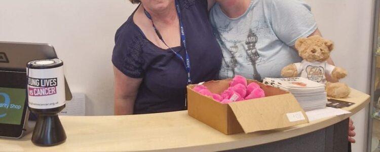 Carla and Bev volunteering at our charity shop - stood behind the counter