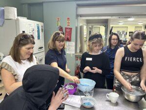 young people and staff doing experiments in the cafe kitchen