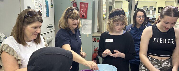 young people and staff doing experiments in the cafe kitchen