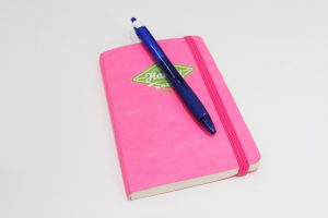pink diary and pen