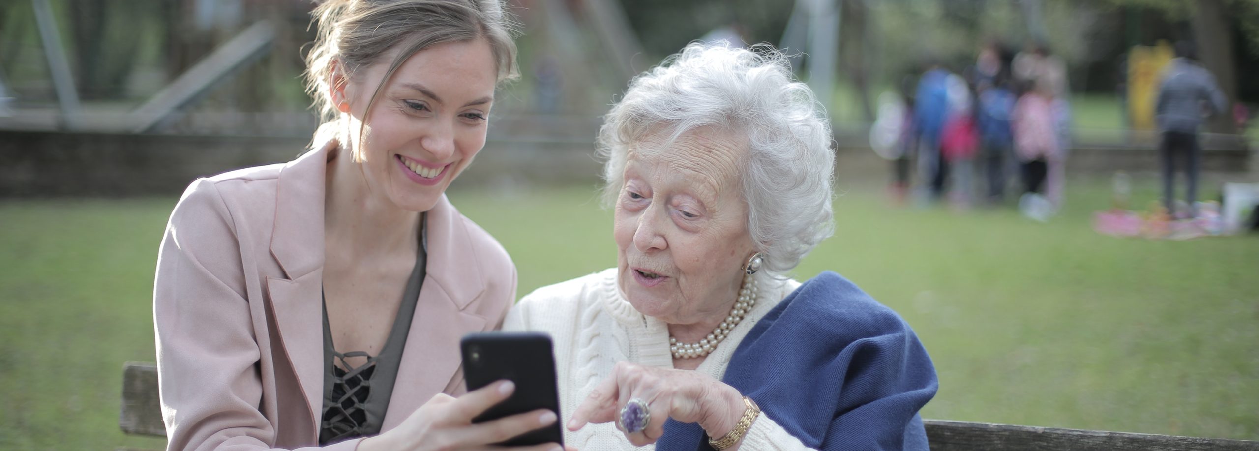 woman showing photo to elderly woman