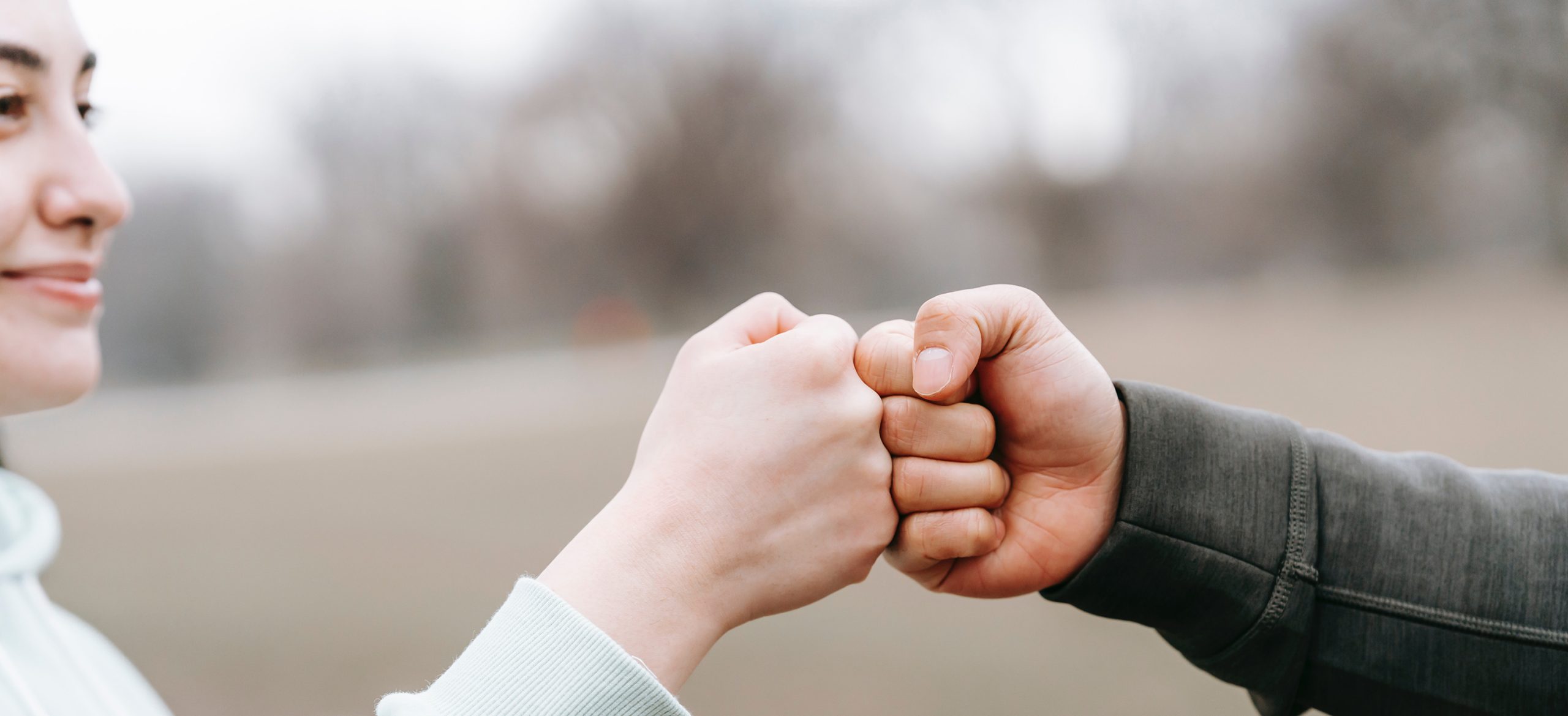 two people fist bumping